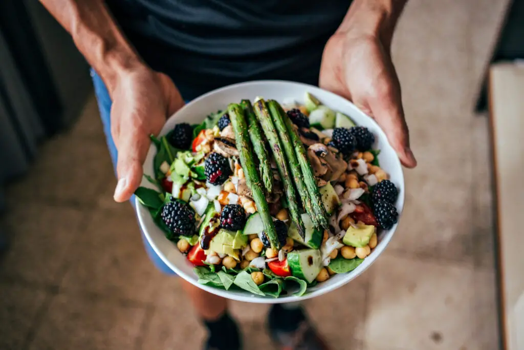 man holding a bowl of food on an insulin resistance diet